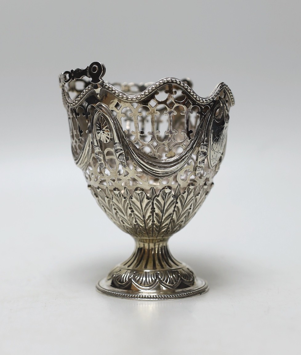 A George III pierced silver vase shaped sugar basket, lacking liner, London, 1775, height 12.6cm, 5.7oz.